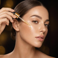 Applying a drop of 24K Gold Serum to the cheek